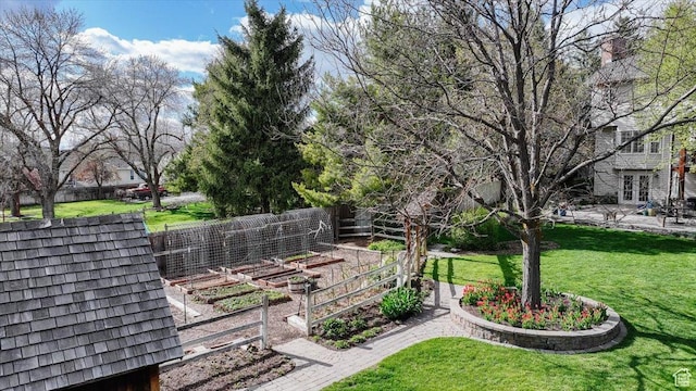 770 Orchard Dr, River Heights, UT 84321 - view of property's community with a yard, a vegetable garden, and fence