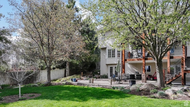 770 Orchard Dr, River Heights, UT 84321 - back of house featuring stairway, a balcony, a lawn, fence, and a patio