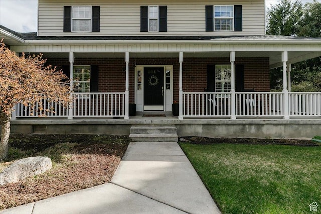 770 Orchard Dr, River Heights, UT 84321 - view of exterior entry with covered porch and brick siding
