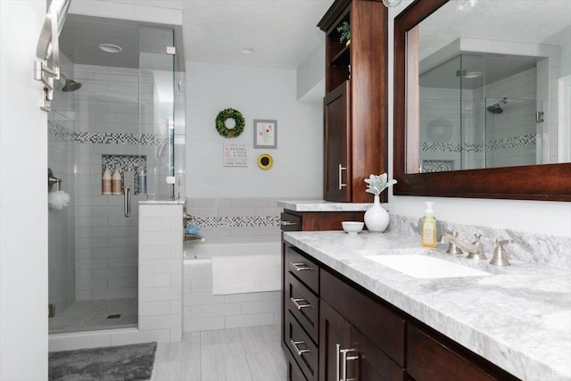 770 Orchard Dr, River Heights, UT 84321 - bathroom with a garden tub, vanity, tile patterned floors, and a stall shower