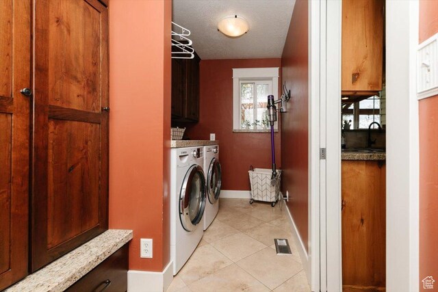 770 Orchard Dr, River Heights, UT 84321 - laundry room with visible vents, light tile patterned flooring, baseboards, separate washer and dryer, and cabinet space
