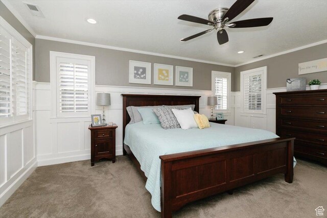 770 Orchard Dr, River Heights, UT 84321 - bedroom featuring wainscoting, light carpet, crown molding, and a decorative wall