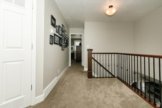 770 Orchard Dr, River Heights, UT 84321 - hall with a textured ceiling, an upstairs landing, carpet, baseboards, and visible vents