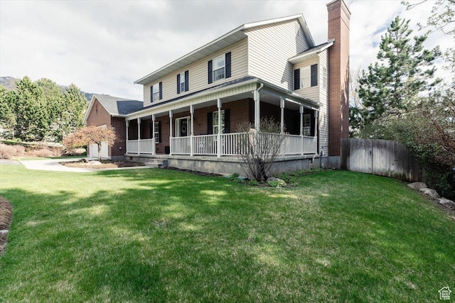 770 Orchard Dr, River Heights, UT 84321 - country-style home with a front lawn, a porch, a chimney, fence, and brick siding
