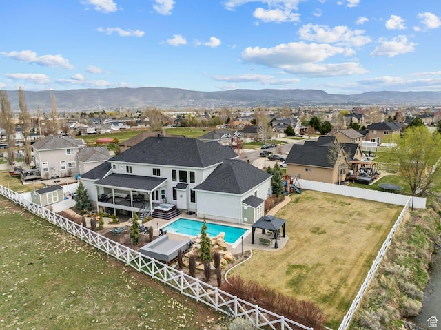 birds eye view of property with a mountain view and a residential view