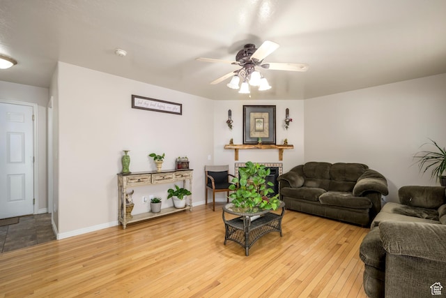 1426 N Quincy Ave, Ogden, UT 84404 - living room featuring light wood finished floors, a ceiling fan, baseboards, and a fireplace