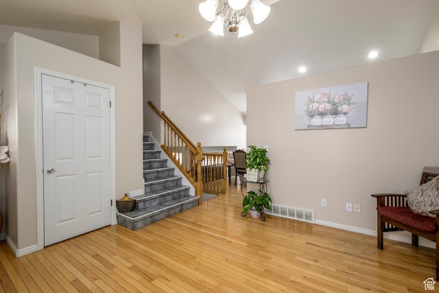 1426 N Quincy Ave, Ogden, UT 84404 - living area with wood-type flooring, lofted ceiling, stairs, and visible vents