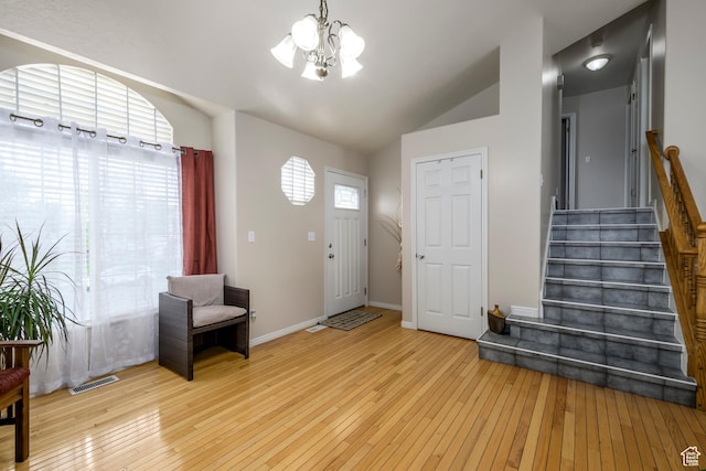 1426 N Quincy Ave, Ogden, UT 84404 - entryway featuring visible vents, a notable chandelier, lofted ceiling, stairway, and hardwood / wood-style floors