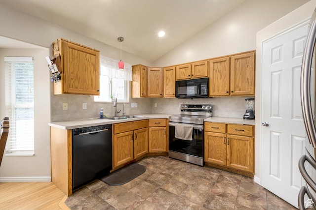 1426 N Quincy Ave, Ogden, UT 84404 - kitchen with light countertops, lofted ceiling, a sink, and black appliances