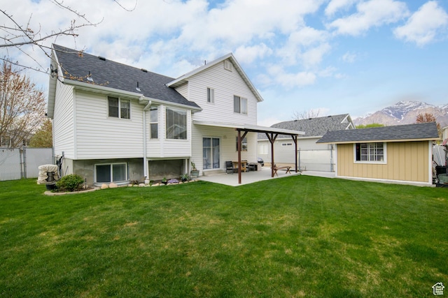 1426 N Quincy Ave, Ogden, UT 84404 - back of house with a mountain view, fence, a garage, a yard, and a patio