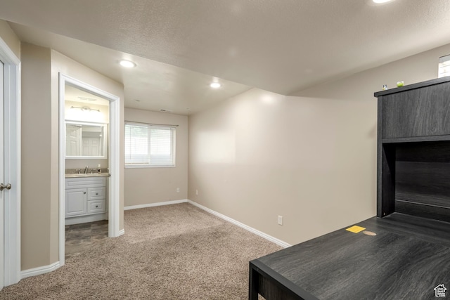 1426 N Quincy Ave, Ogden, UT 84404 - interior space featuring a textured ceiling, a sink, baseboards, carpet, and recessed lighting