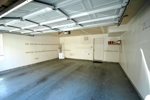 garage with baseboards and a garage door opener
