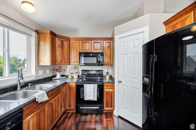 818 W 530 S, Logan, UT 84321 - kitchen featuring black appliances, lofted ceiling, dark wood-style flooring, brown cabinets, and dark countertops