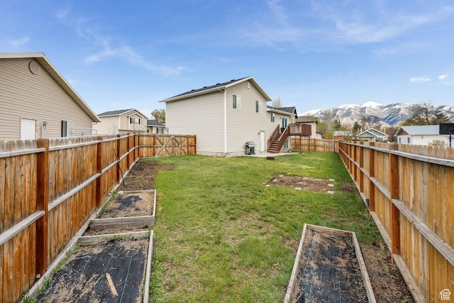 818 W 530 S, Logan, UT 84321 - fenced backyard with a vegetable garden, stairs, and a deck with mountain view