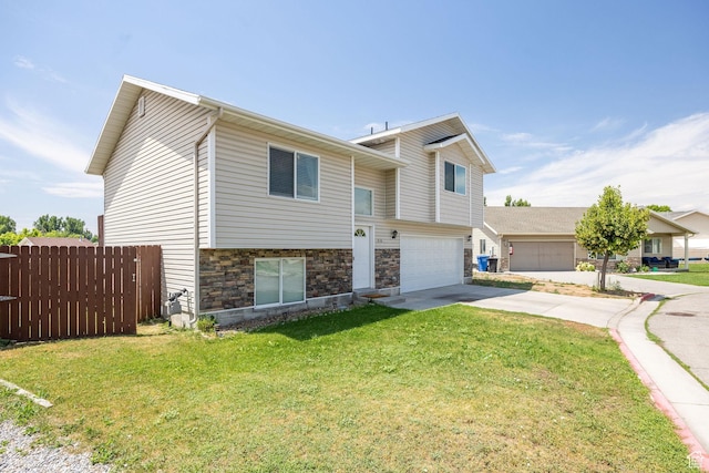 818 W 530 S, Logan, UT 84321 - raised ranch with driveway, stone siding, and an attached garage
