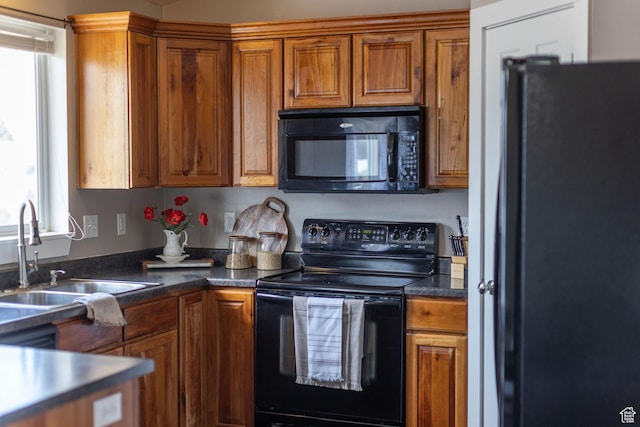 818 W 530 S, Logan, UT 84321 - kitchen featuring black appliances, brown cabinets, and dark countertops