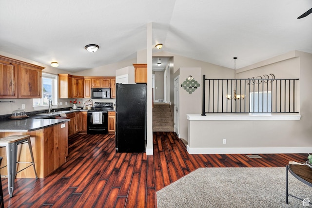 818 W 530 S, Logan, UT 84321 - kitchen featuring black appliances, dark countertops, brown cabinetry, lofted ceiling, and dark wood finished floors