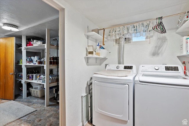 clothes washing area with washing machine and clothes dryer and laundry area