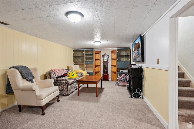 carpeted living area with stairway