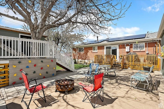 view of patio / terrace featuring stairway and an outdoor fire pit