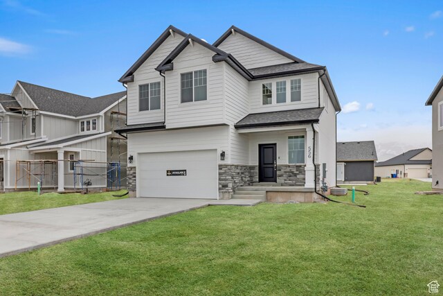 556 N 800 W, Smithfield, UT 84335 - craftsman inspired home featuring stone siding, concrete driveway, fence, an attached garage, and a front yard