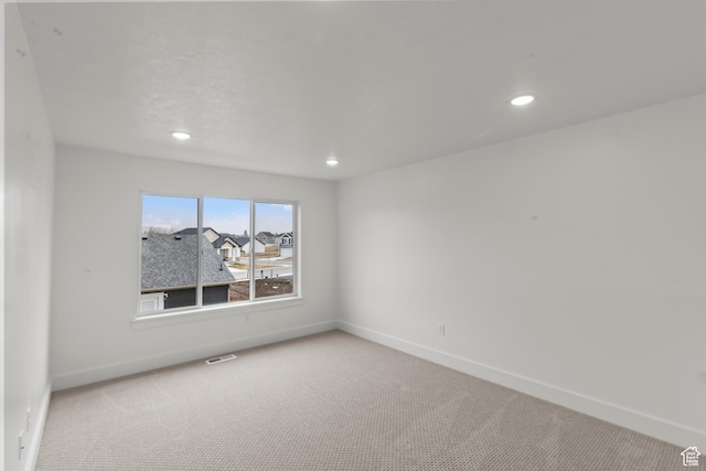 556 N 800 W, Smithfield, UT 84335 - unfurnished room featuring light colored carpet, baseboards, visible vents, and recessed lighting