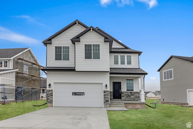 craftsman inspired home with a front lawn, stone siding, concrete driveway, fence, and a garage