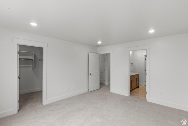 556 N 800 W, Smithfield, UT 84335 - unfurnished bedroom with baseboards, recessed lighting, light colored carpet, ensuite bath, and a walk in closet