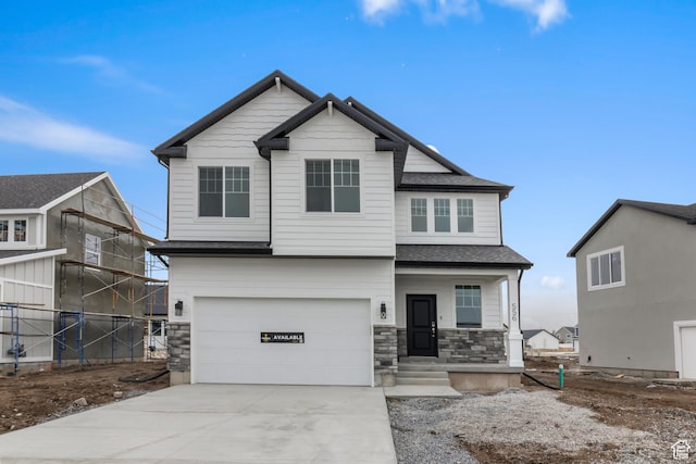 556 N 800 W, Smithfield, UT 84335 - craftsman-style house featuring fence, concrete driveway, an attached garage, covered porch, and stone siding