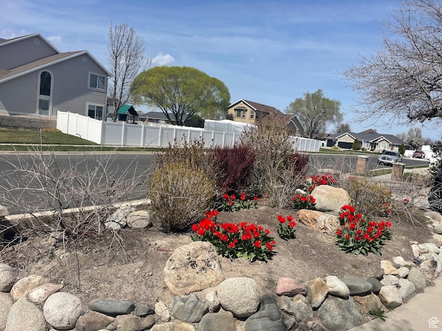 view of yard featuring fence and a residential view