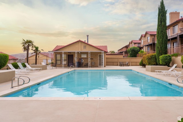 community pool featuring a patio and fence