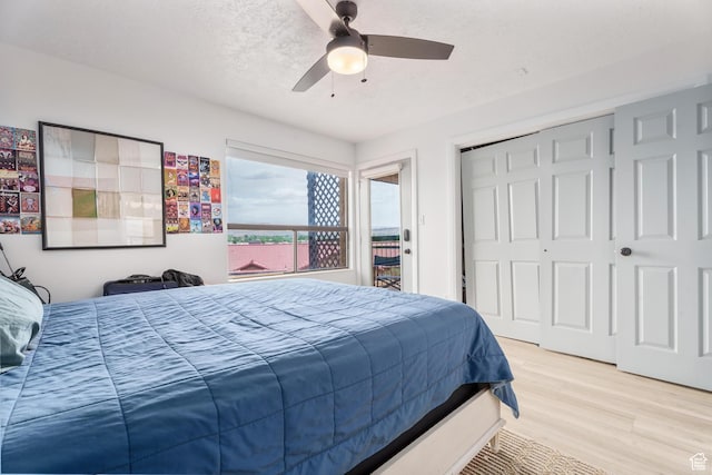 bedroom featuring a ceiling fan, wood finished floors, and a closet