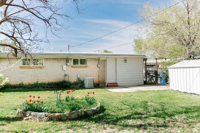850 N 744 E, Ogden, UT 84404 - rear view of house with a shed, cooling unit, an outbuilding, and a lawn