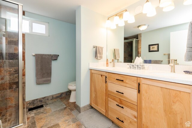 1550 E 2100 N, North Logan, UT 84341 - bathroom with a sink, a stall shower, double vanity, toilet, and stone finish floor