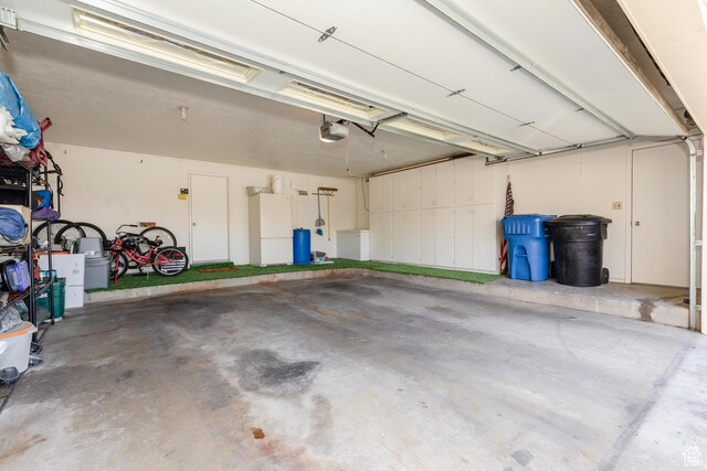 1550 E 2100 N, North Logan, UT 84341 - garage with freestanding refrigerator and a garage door opener