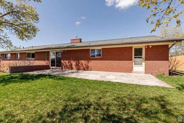 1550 E 2100 N, North Logan, UT 84341 - rear view of property featuring a yard, a chimney, a patio, and fence