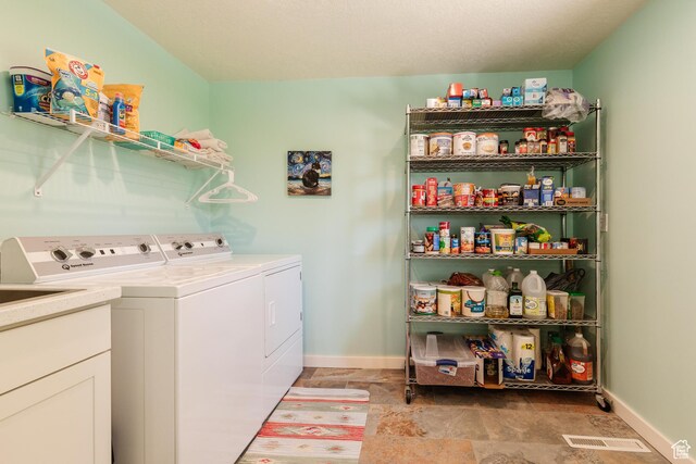 1550 E 2100 N, North Logan, UT 84341 - clothes washing area featuring stone finish floor, baseboards, washer and clothes dryer, and laundry area
