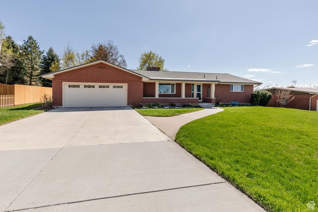 1550 E 2100 N, North Logan, UT 84341 - ranch-style house featuring brick siding, an attached garage, fence, and driveway