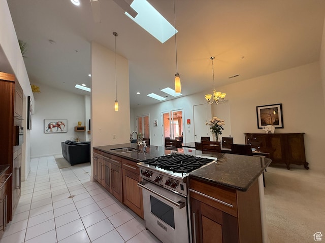 1999 W Canyon Dr Unit 3, St George, UT 84770 - kitchen with dark stone countertops, a sink, hanging light fixtures, light tile patterned flooring, and high end stainless steel range oven