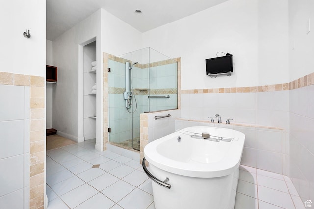 1999 W Canyon Dr Unit 3, St George, UT 84770 - bathroom with a freestanding bath, tile walls, wainscoting, tile patterned flooring, and a shower stall
