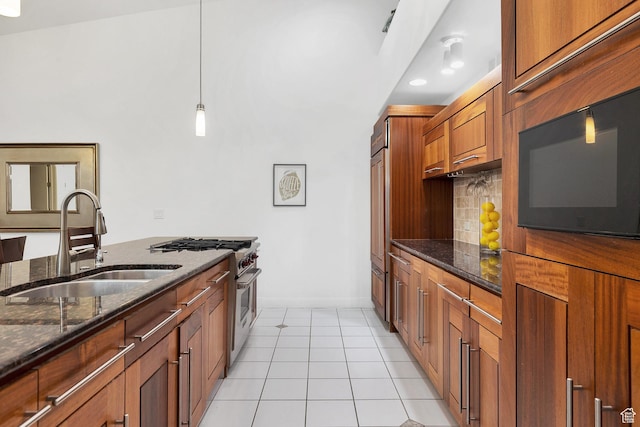 1999 W Canyon Dr Unit 3, St George, UT 84770 - kitchen featuring high end appliances, a sink, dark stone counters, baseboards, and tasteful backsplash