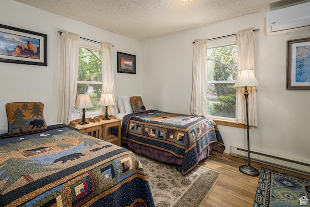 168 S 100 W, Moab, UT 84532 - bedroom with a baseboard heating unit, wood finished floors, a textured ceiling, and a wall unit AC