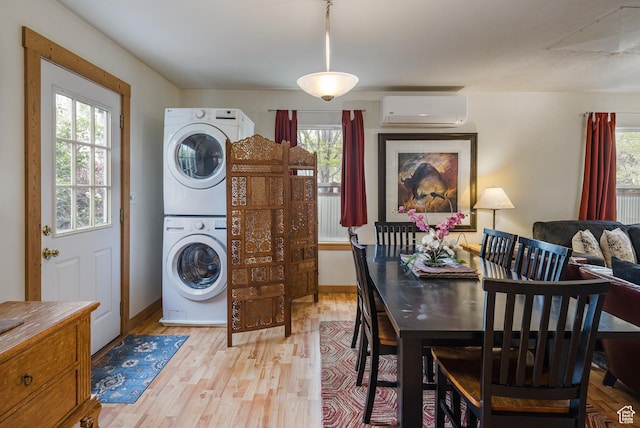 168 S 100 W, Moab, UT 84532 - laundry area with stacked washer and dryer, a wall unit AC, a healthy amount of sunlight, and laundry area