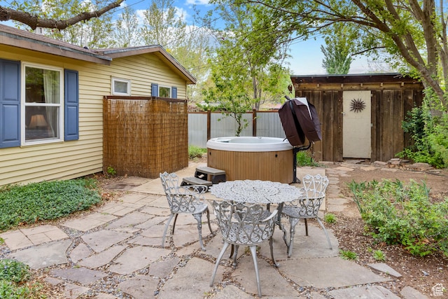 168 S 100 W, Moab, UT 84532 - view of patio featuring fence, outdoor dining area, and a hot tub
