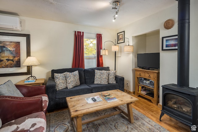 168 S 100 W, Moab, UT 84532 - living area featuring light wood-style flooring, a wall mounted AC, and a wood stove