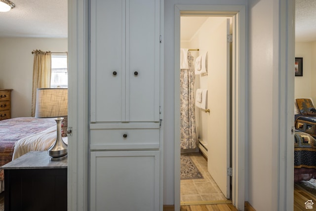 168 S 100 W, Moab, UT 84532 - corridor with light wood-style floors, a textured ceiling, and baseboard heating