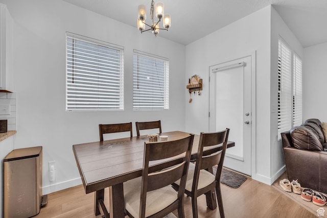 1578 W Andover Rd S, South Jordan, UT 84095 - dining space with light wood-style flooring, baseboards, and a notable chandelier