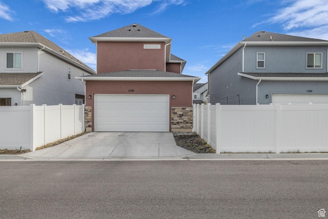 1578 W Andover Rd S, South Jordan, UT 84095 - traditional home featuring concrete driveway, stone siding, a shingled roof, fence, and a garage