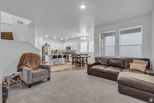 1578 W Andover Rd S, South Jordan, UT 84095 - living area featuring recessed lighting, visible vents, light carpet, stairs, and a notable chandelier