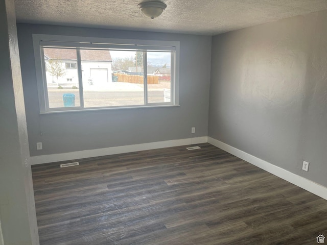 235 W 200 S, Vernal, UT 84078 - unfurnished room featuring dark wood finished floors, a textured ceiling, baseboards, and visible vents